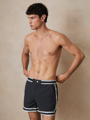 | Ché Stripe-Trim Swim Shorts in Navy