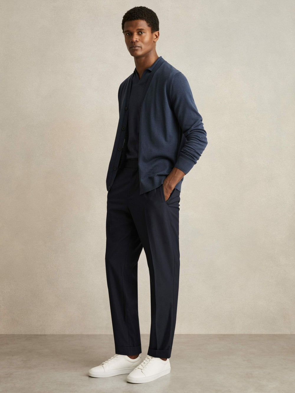 Relaxed-Fit Pleated Tapered Trousers in Navy