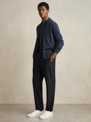 Relaxed-Fit Pleated Tapered Trousers in Navy
