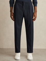 Relaxed-Fit Pleated Tapered Trousers in Navy
