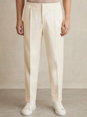 Relaxed-Fit Pleated Tapered Trousers in Ecru