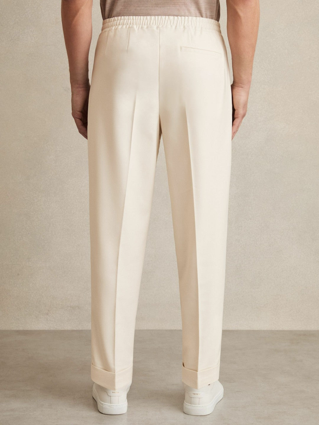 Relaxed-Fit Pleated Tapered Trousers in Ecru