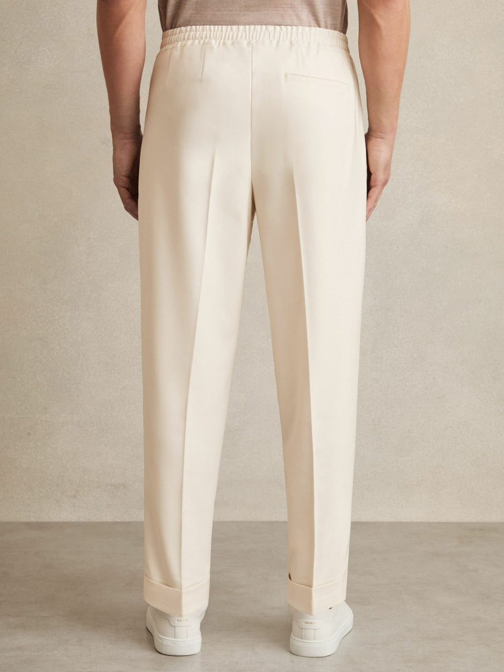 Relaxed-Fit Pleated Tapered Trousers in Ecru