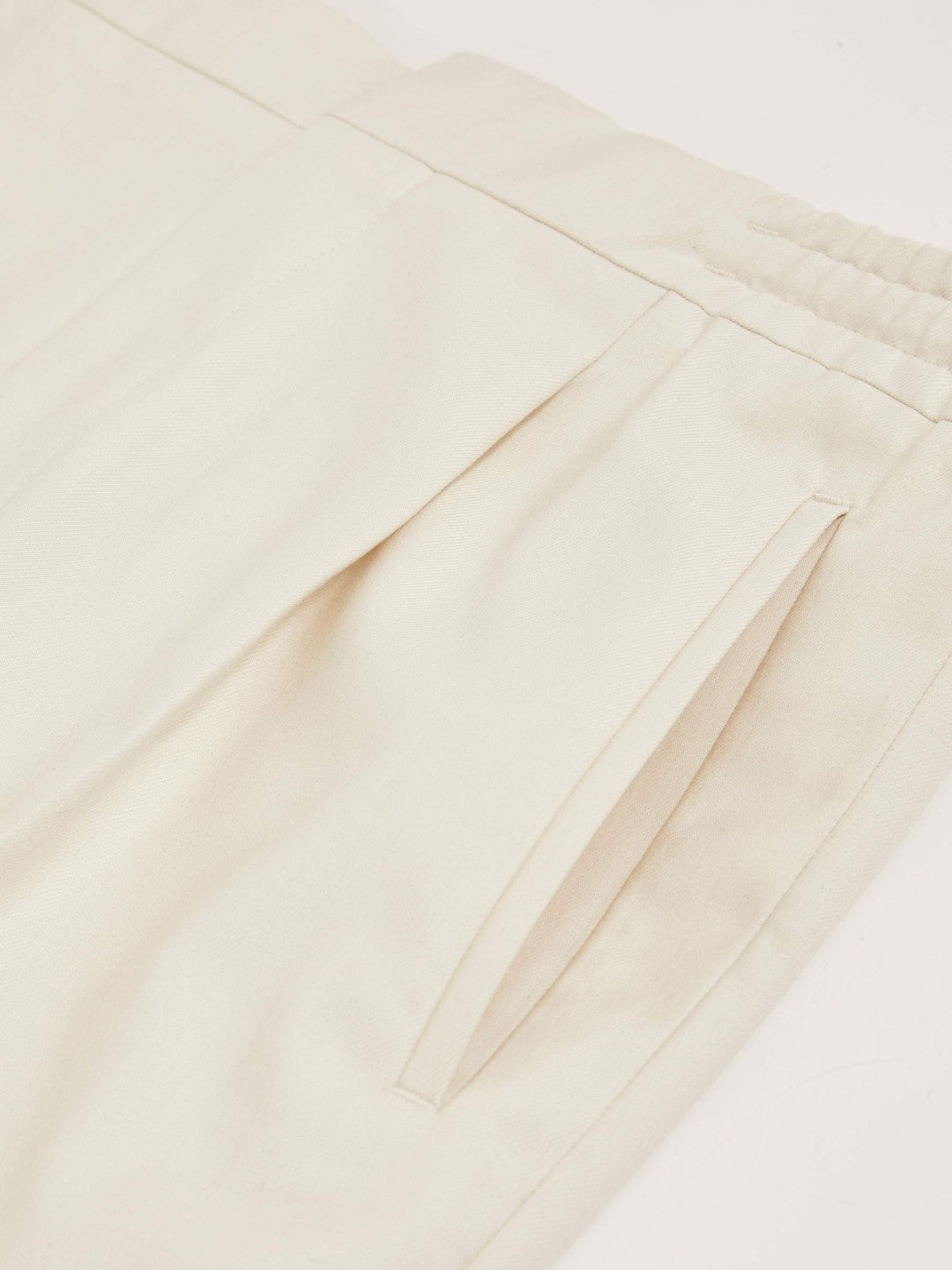 Relaxed-Fit Pleated Tapered Trousers in Ecru