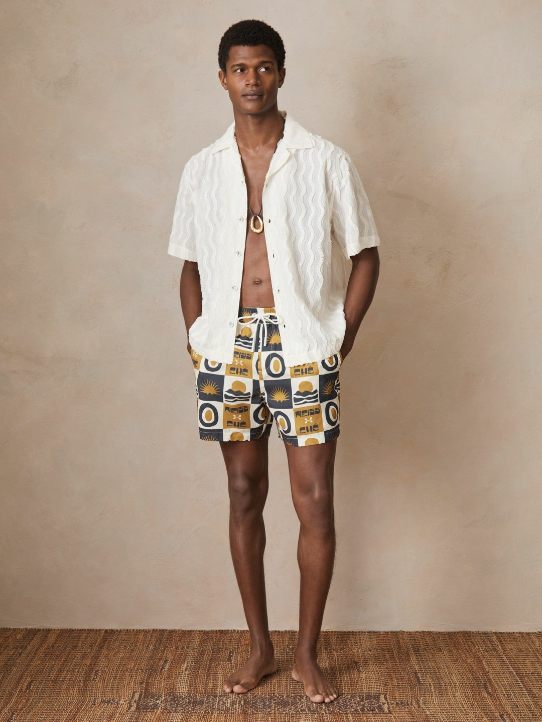 | Ché Sunset-Print Swim Shorts in Olive Green