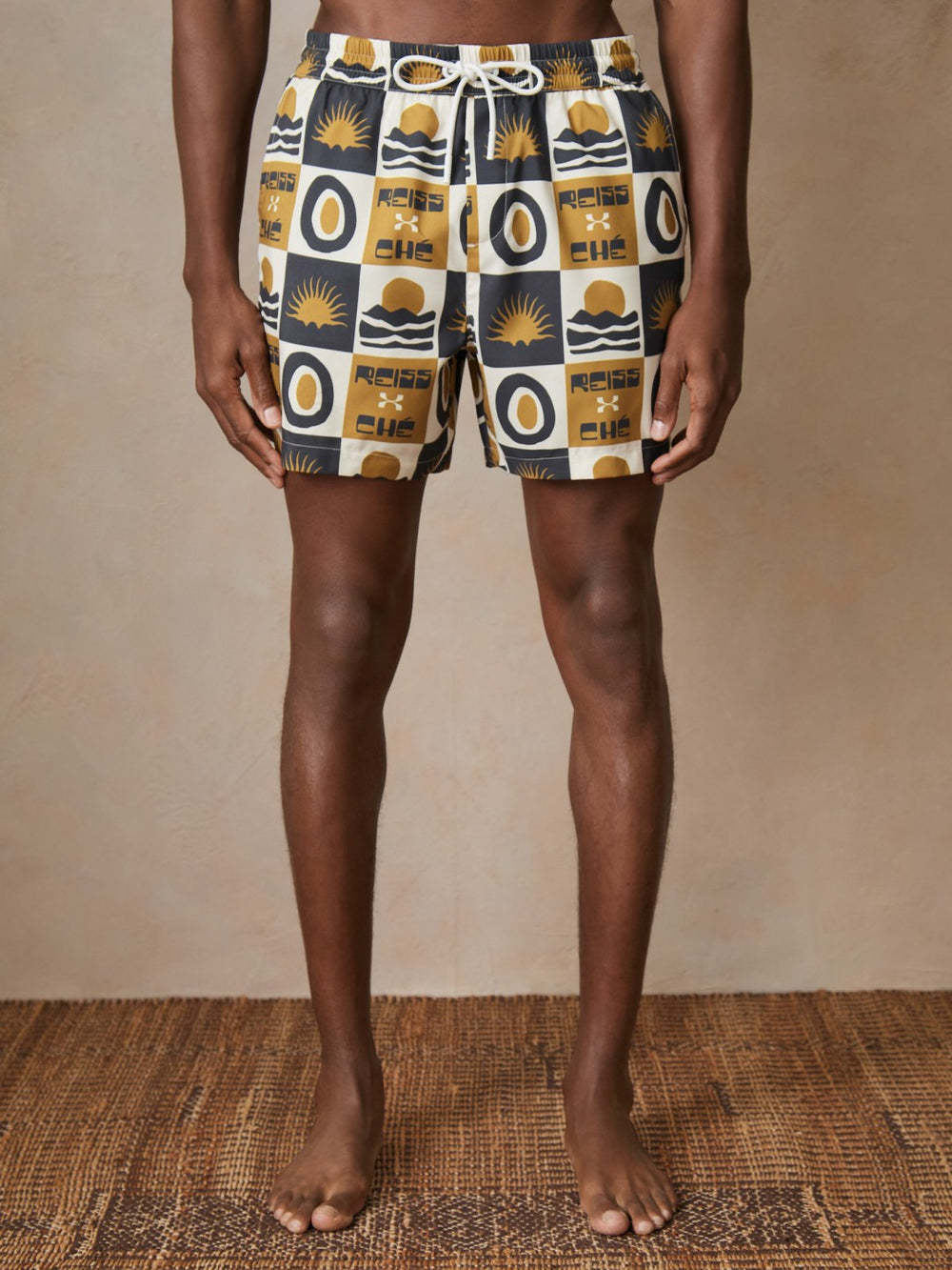 | Ché Sunset-Print Swim Shorts in Olive Green