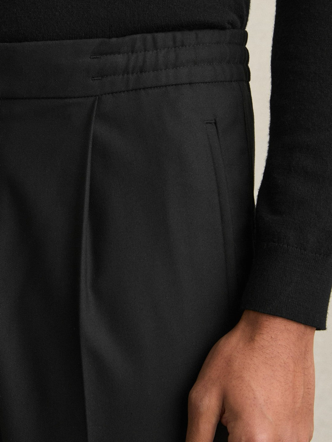 Relaxed-Fit Pleated Tapered Trousers in Black