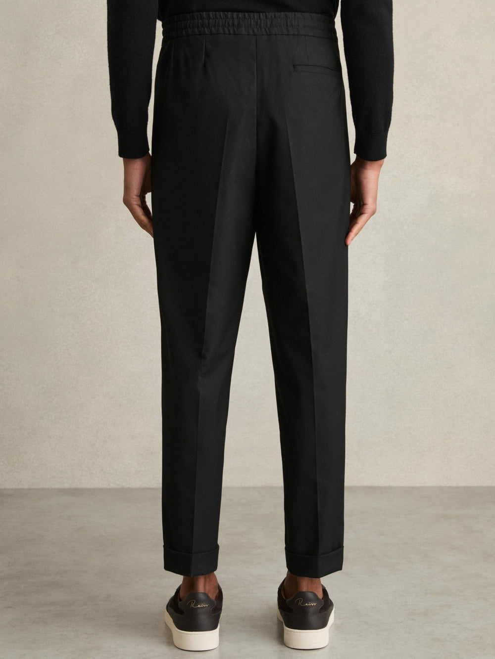 Relaxed-Fit Pleated Tapered Trousers in Black