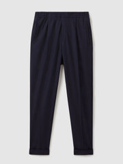Relaxed-Fit Pleated Tapered Trousers in Navy