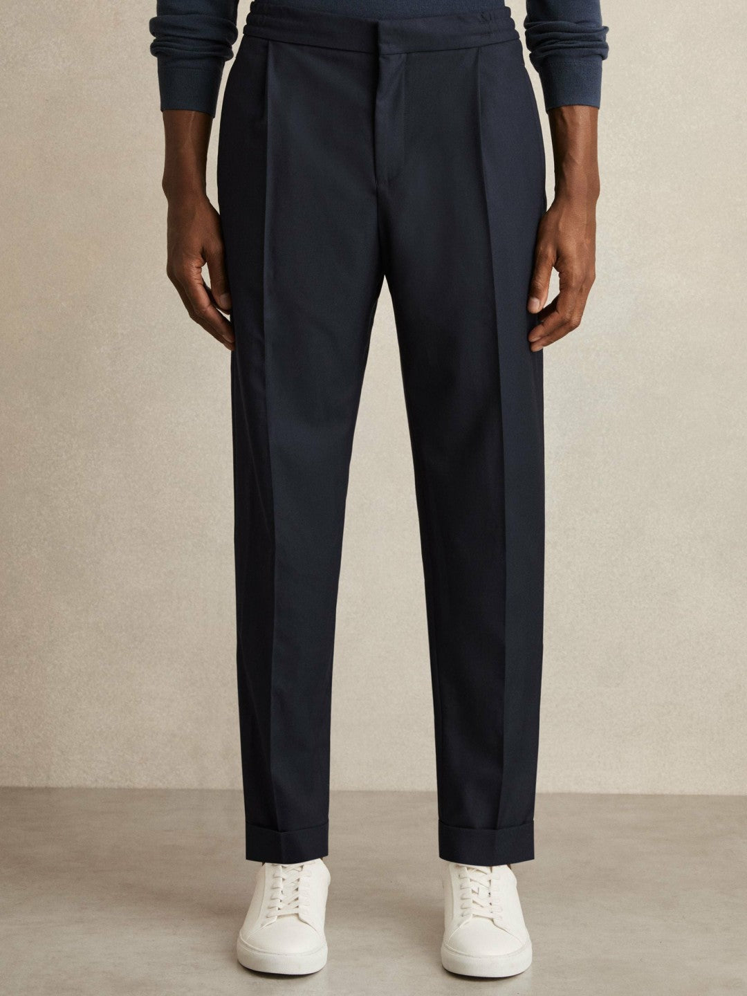 Relaxed-Fit Pleated Tapered Trousers in Navy