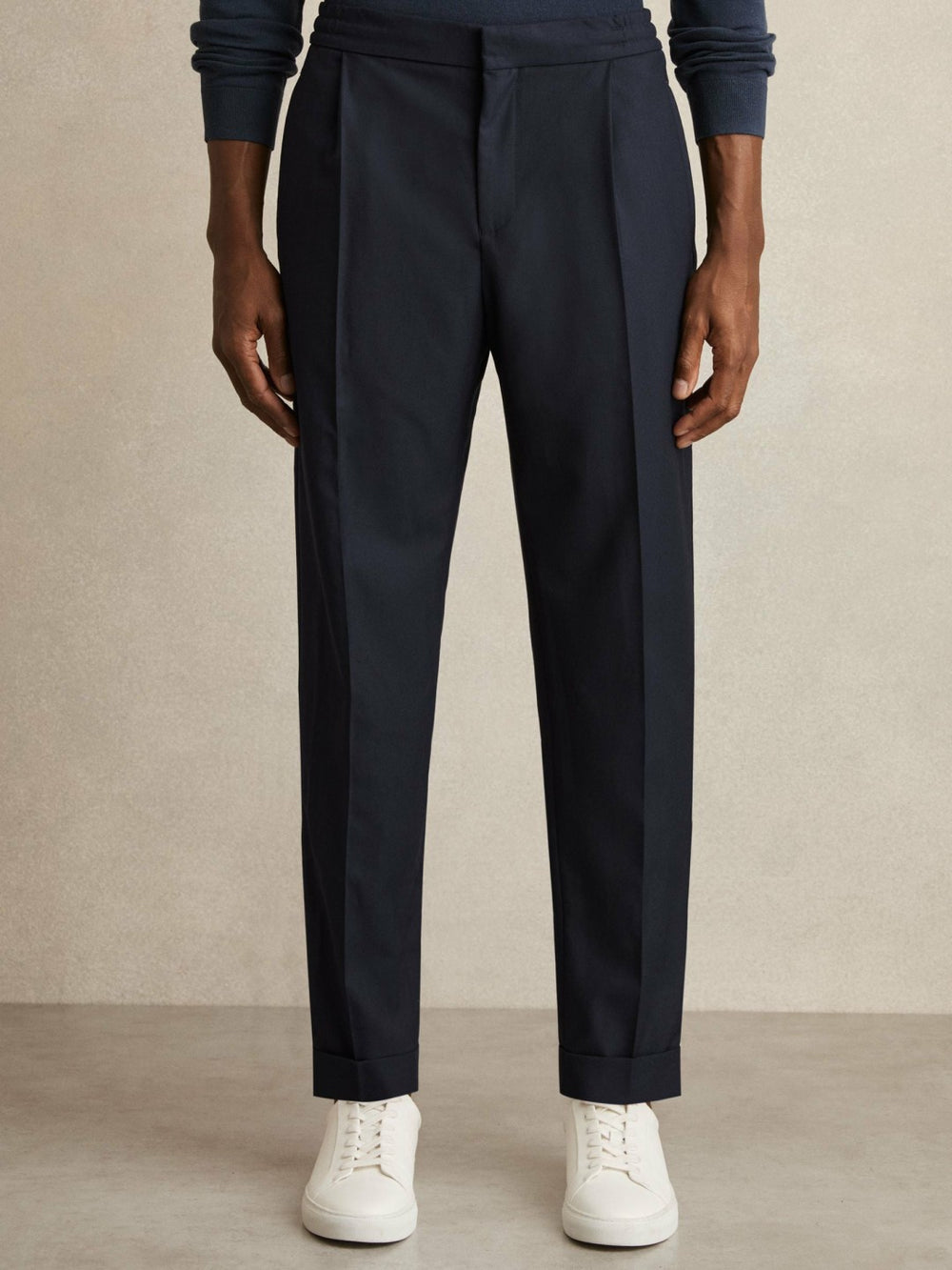 Relaxed-Fit Pleated Tapered Trousers in Navy