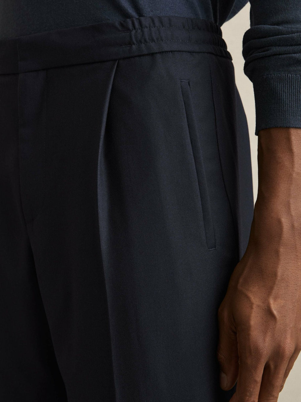 Relaxed-Fit Pleated Tapered Trousers in Navy