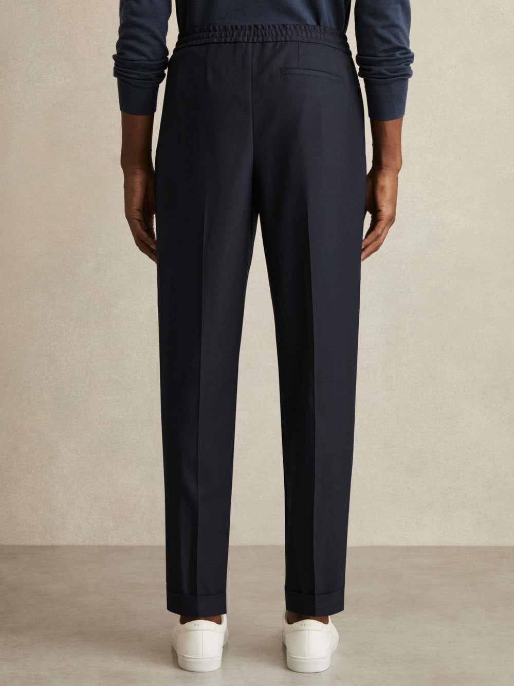Relaxed-Fit Pleated Tapered Trousers in Navy