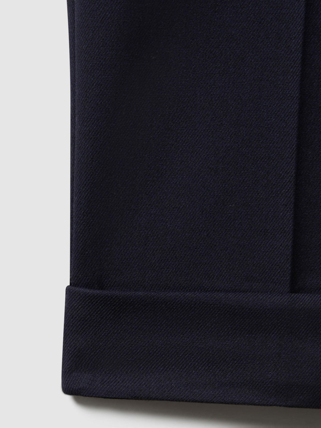 Relaxed-Fit Pleated Tapered Trousers in Navy