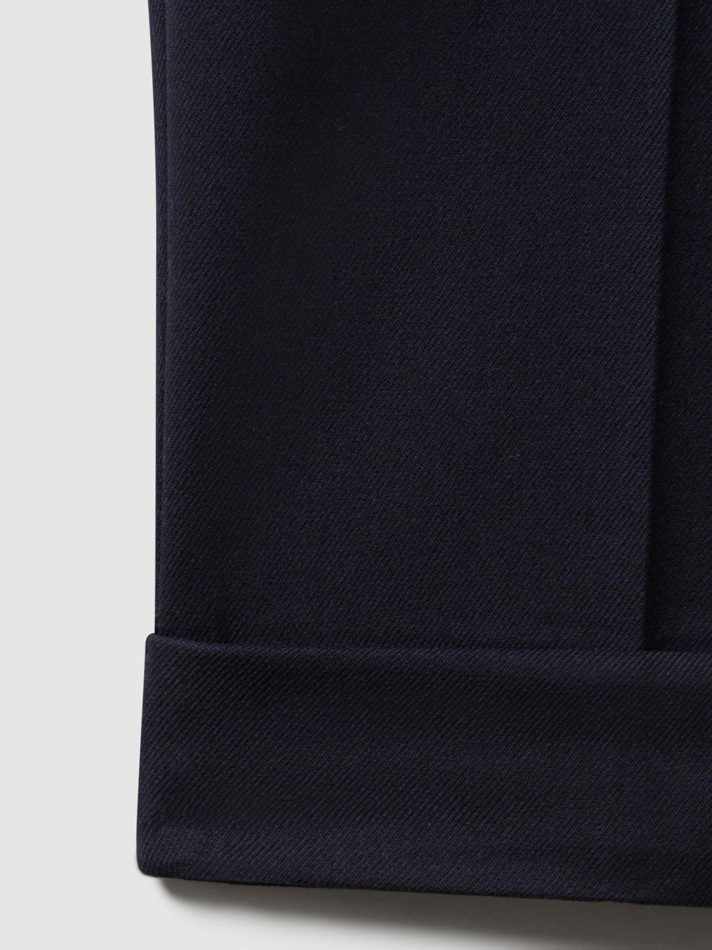 Relaxed-Fit Pleated Tapered Trousers in Navy
